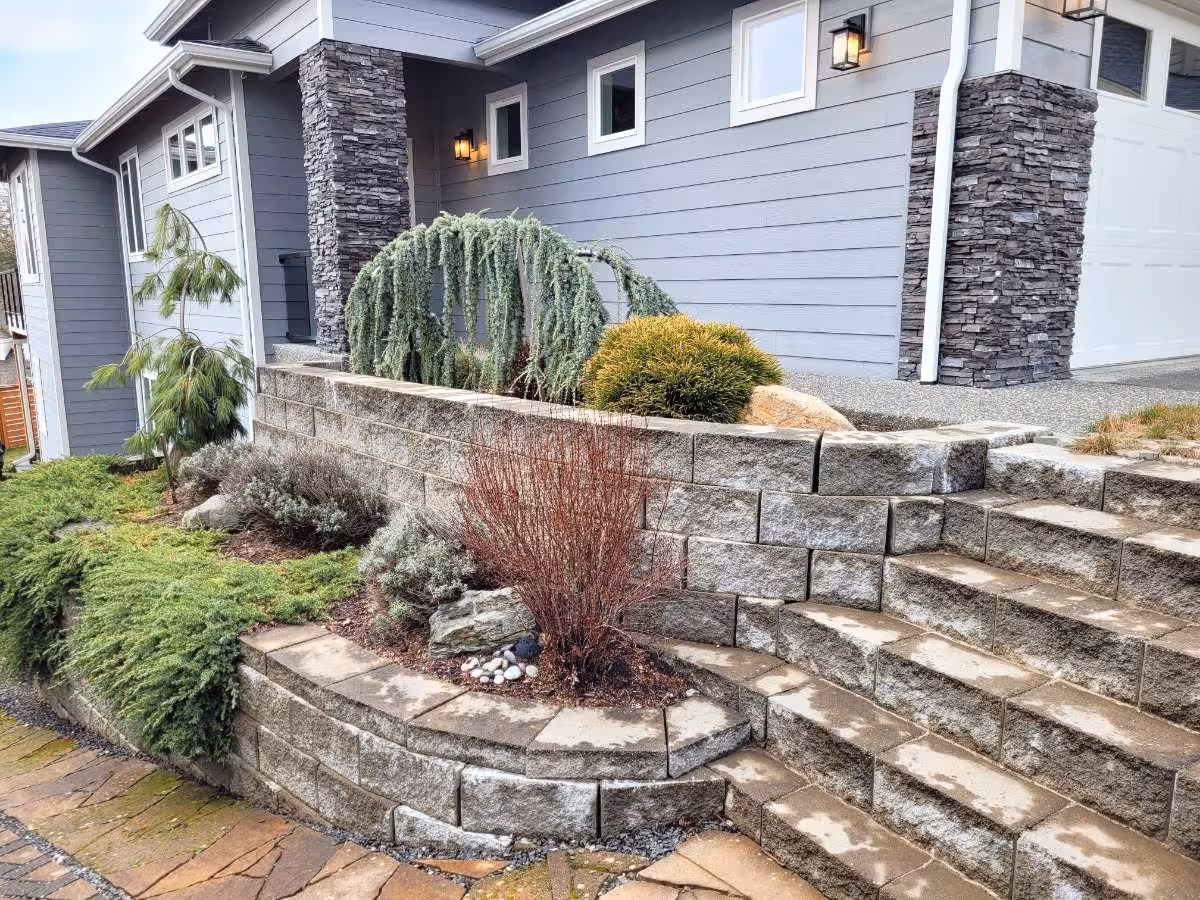 A retaining wall by hardscaped stairs